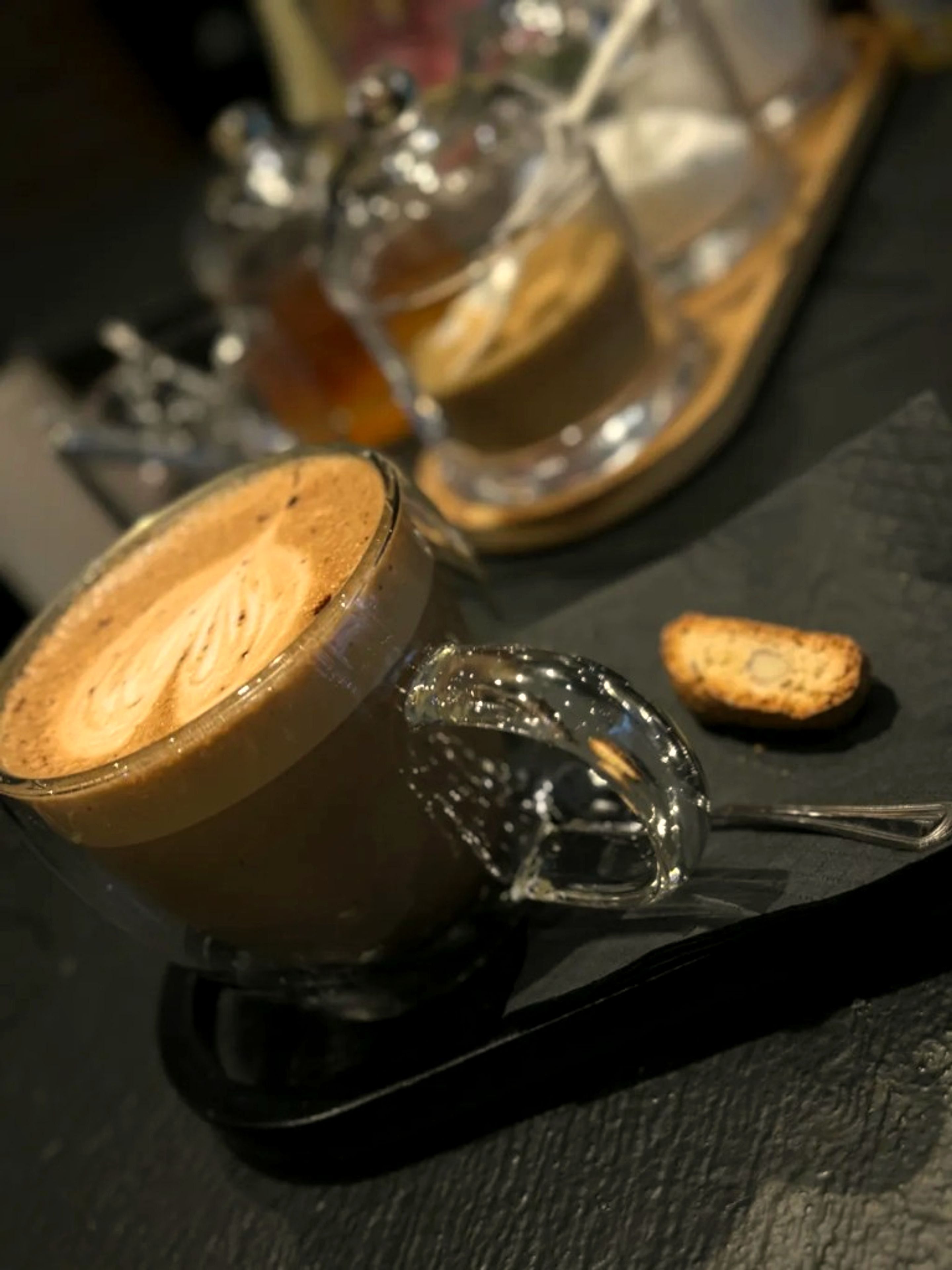 Cappuccino with latte art on a tray at One Gram Coffee Bar