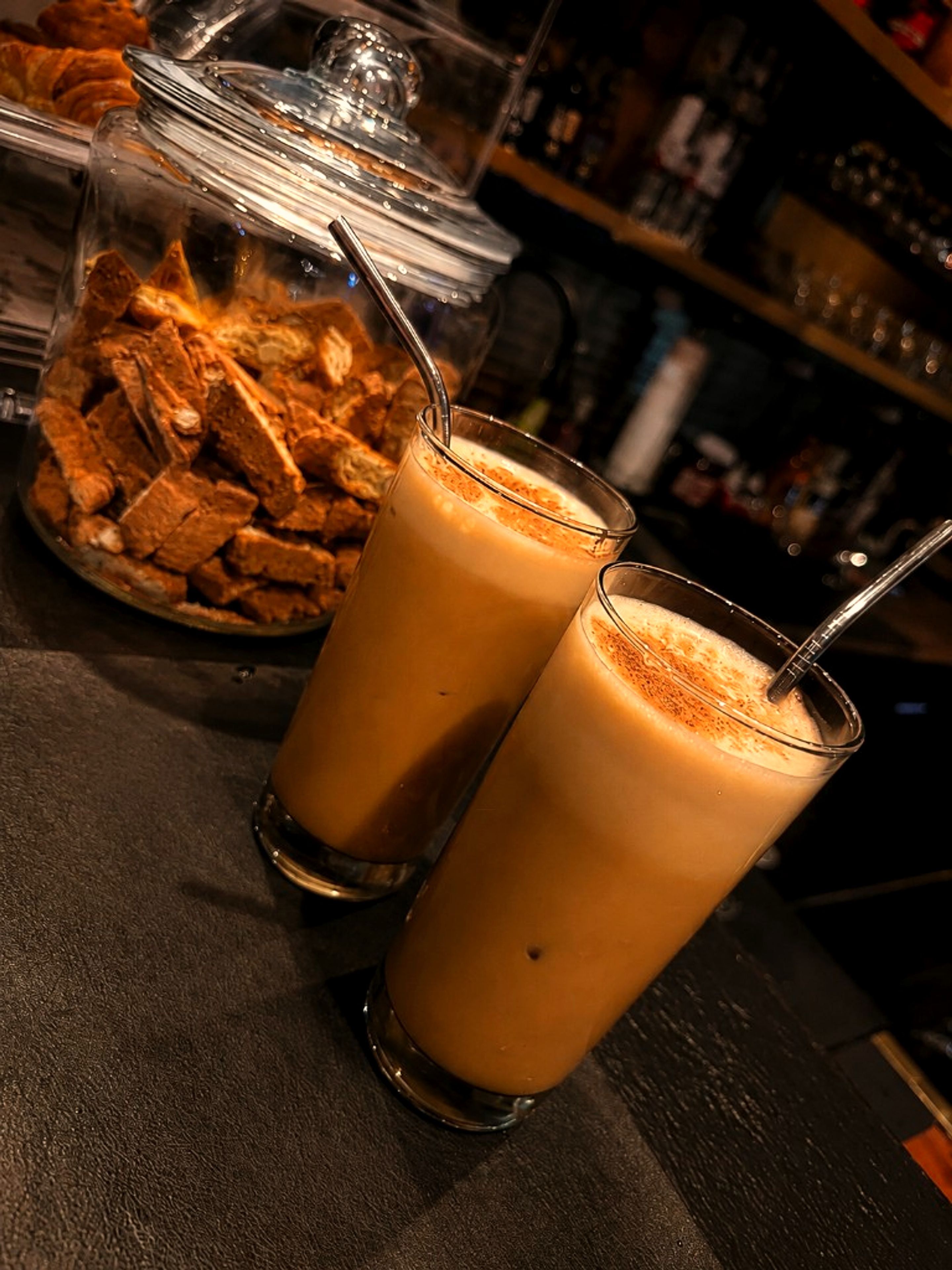 Iced coffees with biscotti at One Gram Coffee Bar