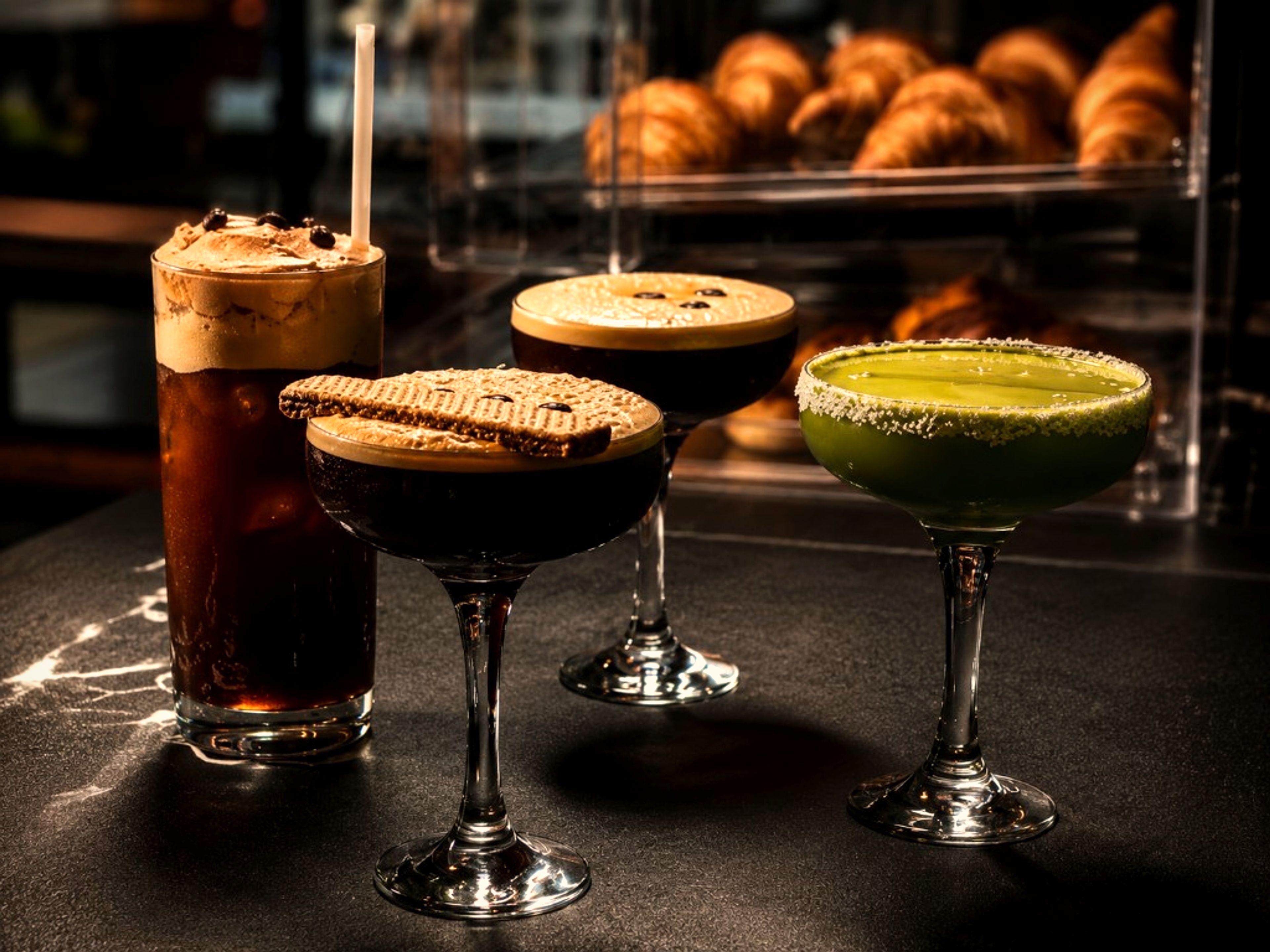 Specialty cocktails lined up at One Gram Coffee Bar
